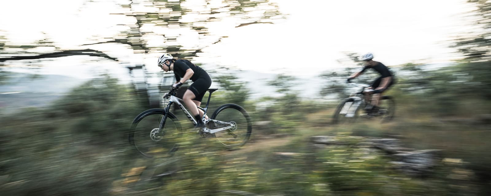 Cyclists riding cross country bikes on a trail